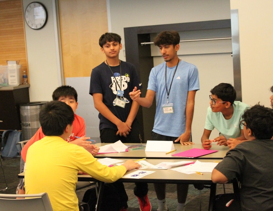 EcoRise students collaborating at a table during a Green Dream Challenge workshop