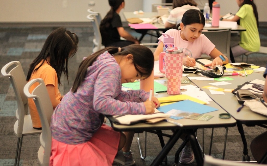 EcoRise students writing and working together during a sustainability workshop