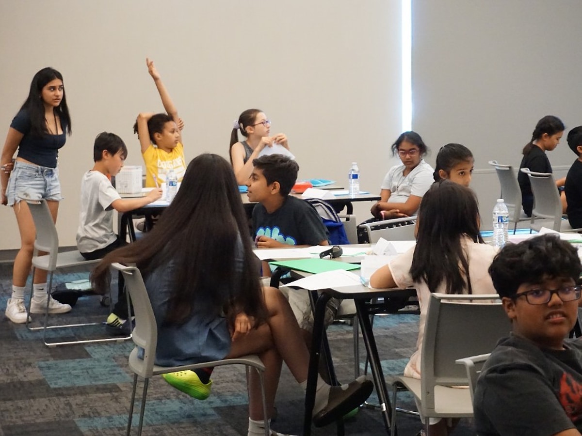 Students reviewing materials during camp